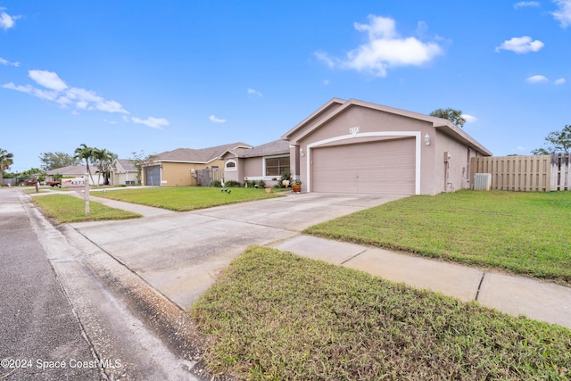 ranch-style house featuring a garage and a front lawn