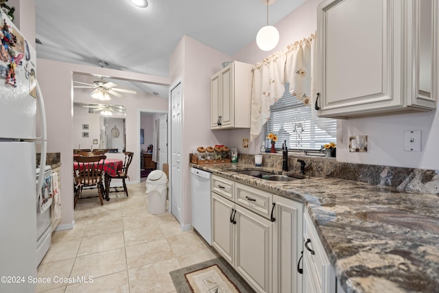 kitchen featuring white appliances, vaulted ceiling, sink, light tile patterned floors, and hanging light fixtures