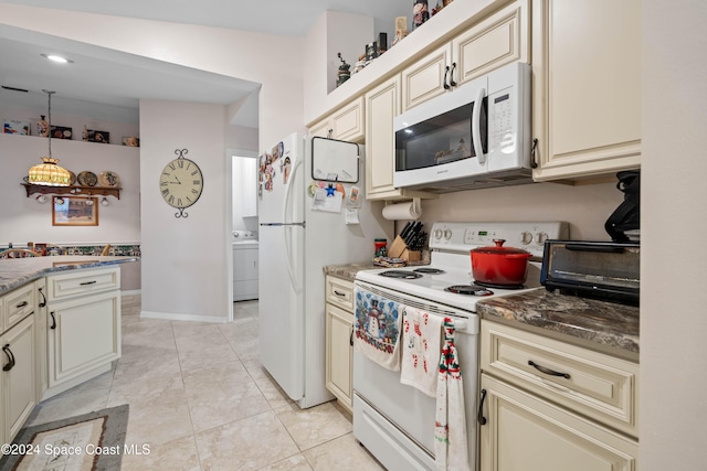 4273 Blue Lake Dr, Melbourne, FL 32901 - kitchen featuring white appliances, cream cabinets, washer / dryer, pendant lighting, and dark stone countertops
