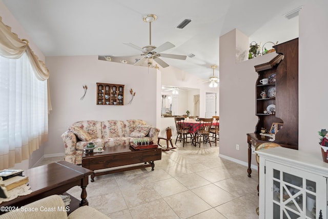 living room with light tile patterned floors and vaulted ceiling