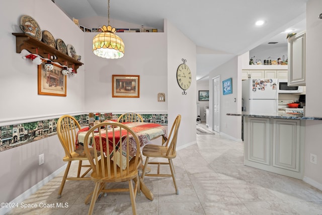 dining area featuring vaulted ceiling