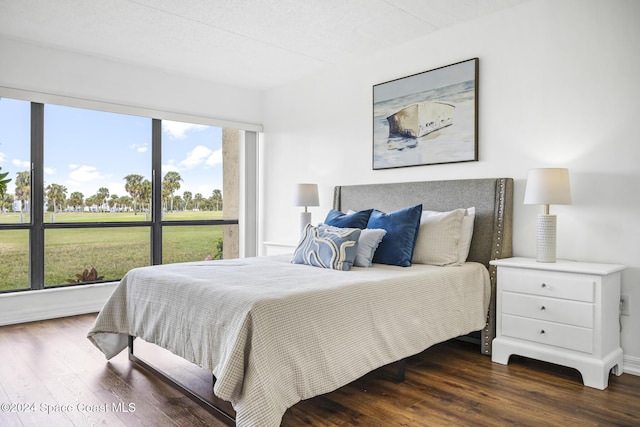 bedroom featuring a textured ceiling and dark wood-type flooring