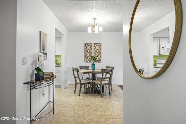 dining room featuring a notable chandelier, light tile patterned flooring, and a textured ceiling