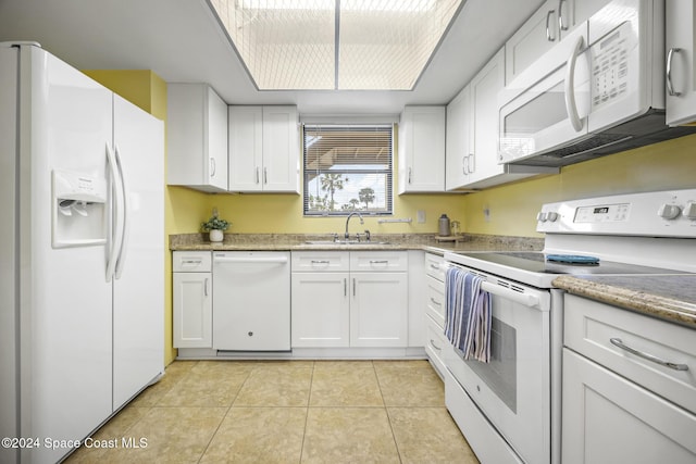 kitchen with sink, white cabinets, and white appliances