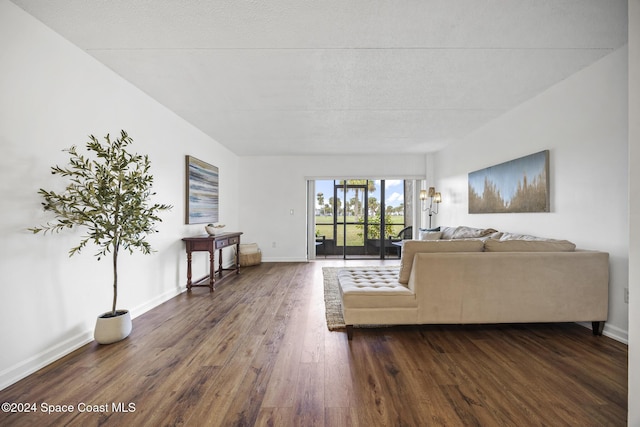 unfurnished living room featuring a textured ceiling and dark wood-type flooring