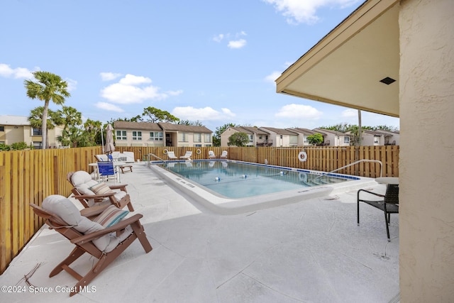 view of swimming pool with a patio