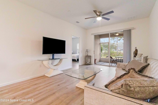 living room featuring ceiling fan and wood-type flooring