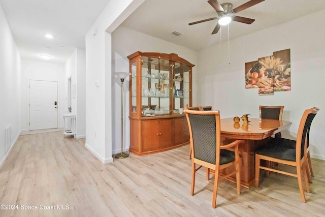 dining area featuring ceiling fan and light wood-type flooring