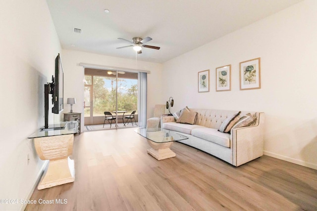 living room featuring light hardwood / wood-style flooring and ceiling fan