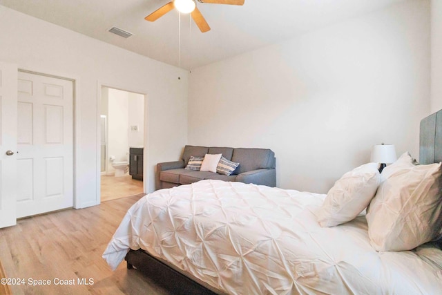 bedroom with ensuite bath, ceiling fan, and wood-type flooring