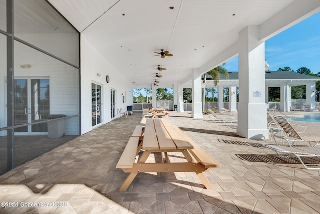 view of patio / terrace with ceiling fan, french doors, and a community pool