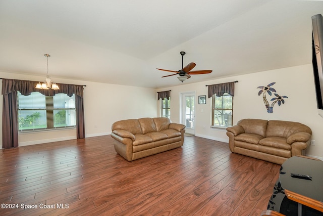 living room featuring lofted ceiling, dark hardwood / wood-style flooring, and ceiling fan with notable chandelier