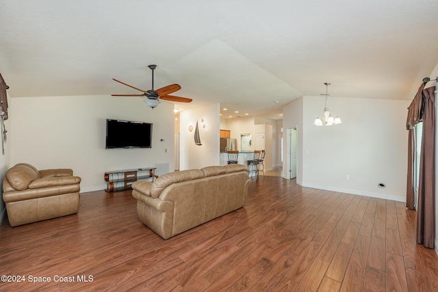 living room featuring ceiling fan with notable chandelier, wood-type flooring, and lofted ceiling