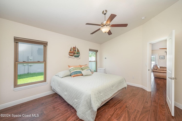 bedroom featuring ceiling fan, dark wood-type flooring, and lofted ceiling