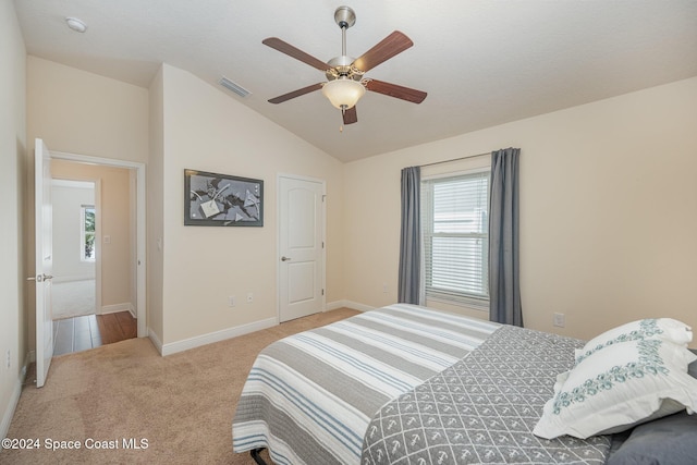 bedroom featuring light carpet, ceiling fan, and lofted ceiling