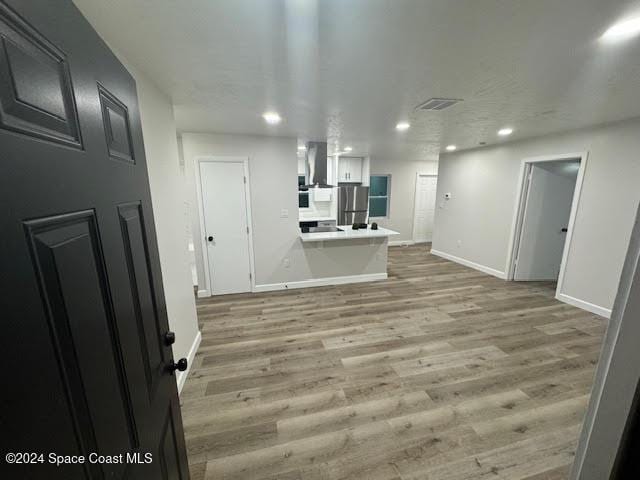 unfurnished living room with light hardwood / wood-style flooring