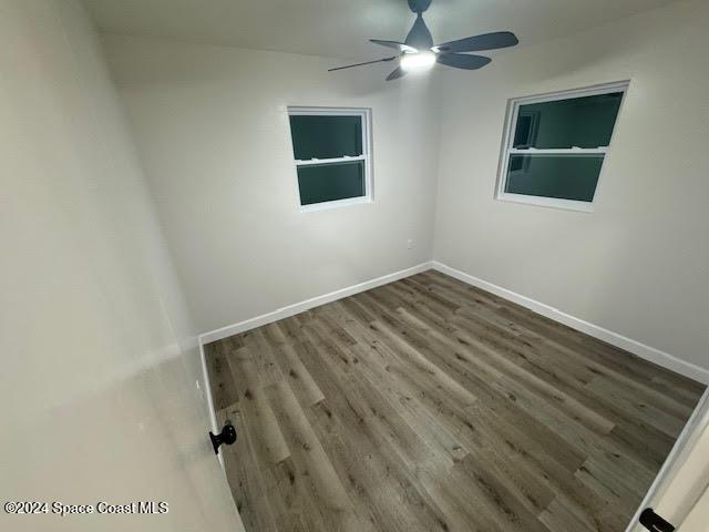 spare room featuring hardwood / wood-style flooring and ceiling fan