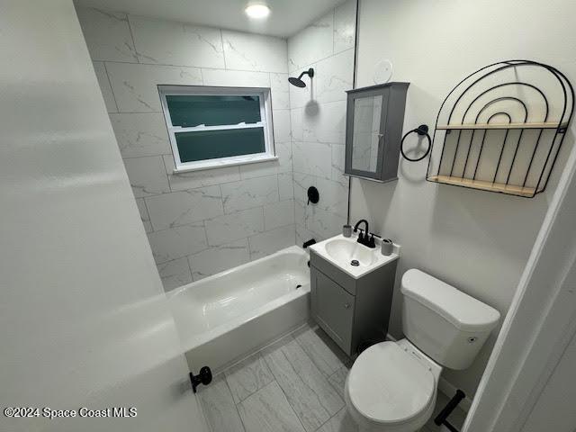 full bathroom with vanity, toilet, and tiled shower / bath