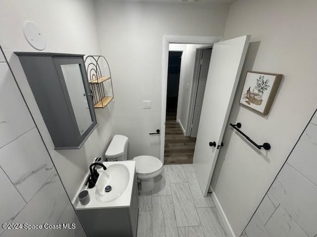 bathroom featuring vanity and toilet