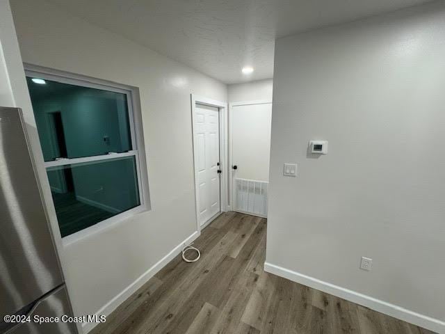 corridor featuring hardwood / wood-style flooring