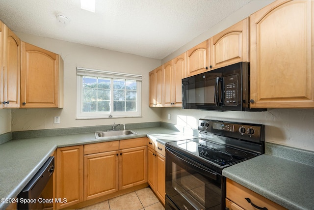 kitchen featuring black appliances, light tile patterned floors, sink, and a textured ceiling