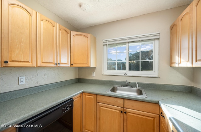 kitchen with a textured ceiling, light brown cabinets, sink, and black dishwasher