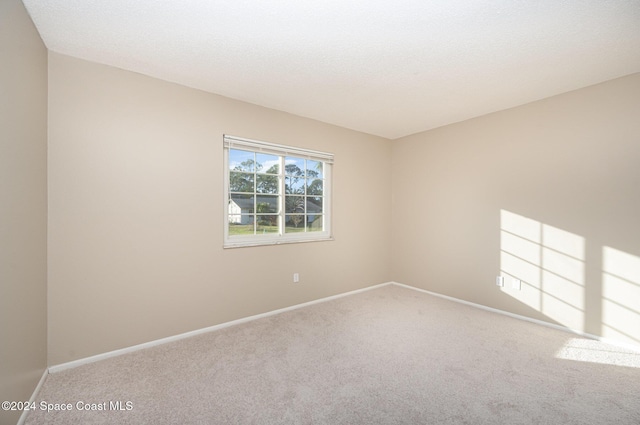 unfurnished room featuring carpet floors and a textured ceiling