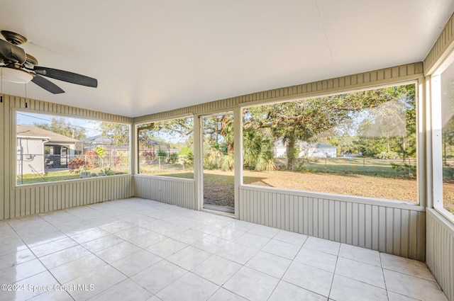 unfurnished sunroom with ceiling fan