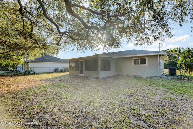 rear view of property featuring a sunroom