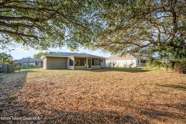 back of property with a sunroom