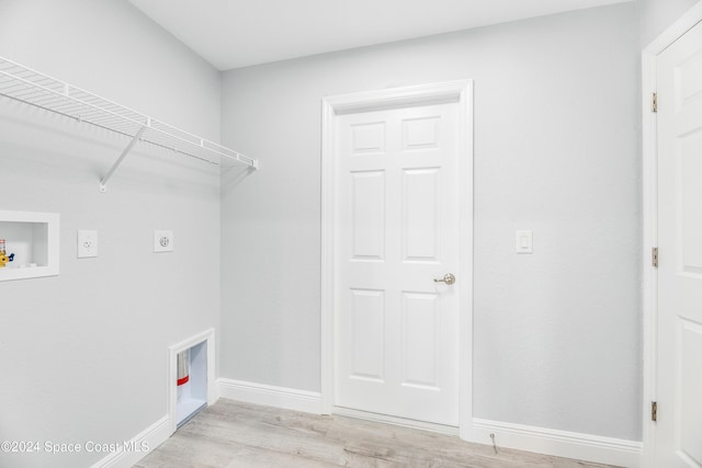 clothes washing area with electric dryer hookup, hookup for a washing machine, and light hardwood / wood-style flooring