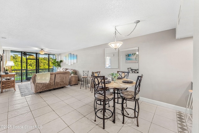 tiled dining area with floor to ceiling windows, ceiling fan, and a textured ceiling