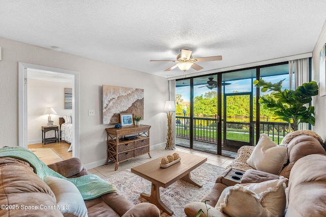 tiled living room featuring a textured ceiling and a wall of windows