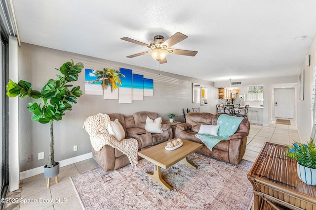 tiled living room with ceiling fan