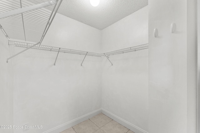 walk in closet featuring light tile patterned floors