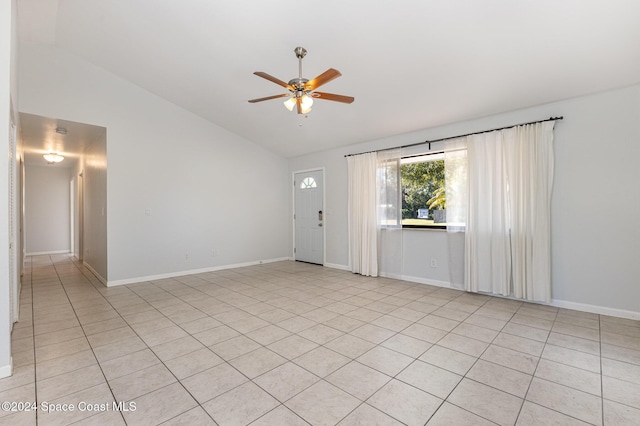 interior space with light tile patterned floors, ceiling fan, and lofted ceiling