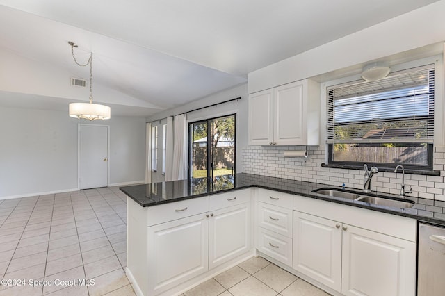 kitchen featuring white cabinets, tasteful backsplash, sink, and vaulted ceiling