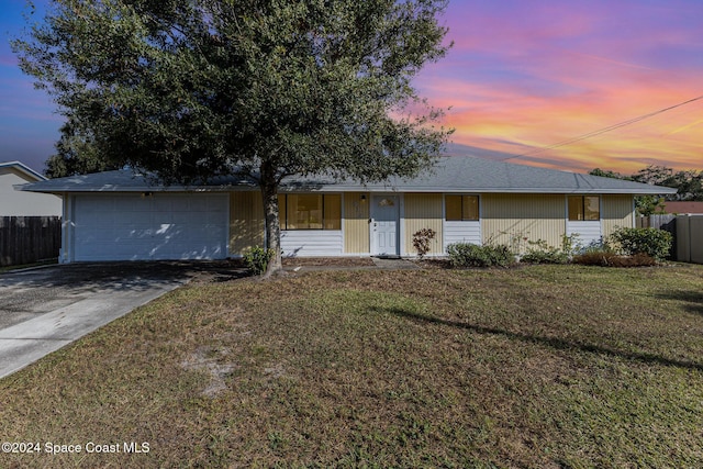 single story home with a lawn and a garage