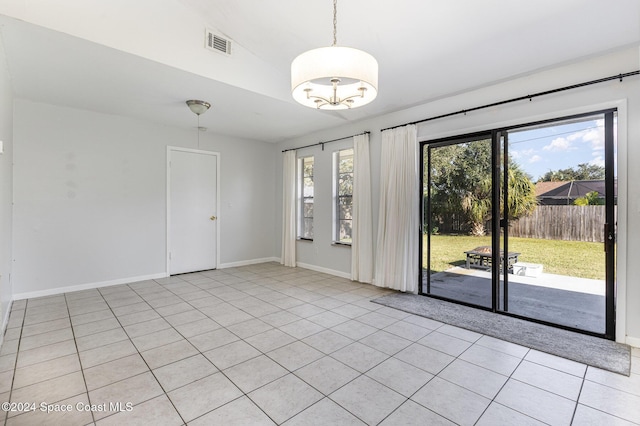 spare room featuring light tile patterned floors and vaulted ceiling