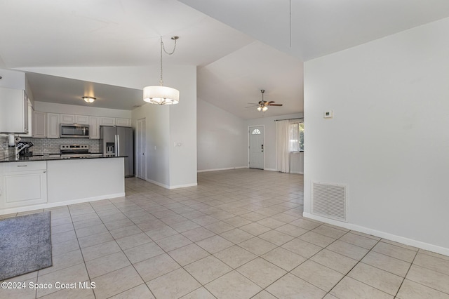 kitchen featuring appliances with stainless steel finishes, backsplash, ceiling fan, pendant lighting, and white cabinetry