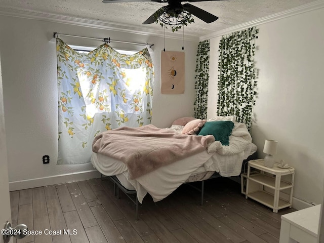 bedroom featuring dark hardwood / wood-style flooring, ceiling fan, and ornamental molding