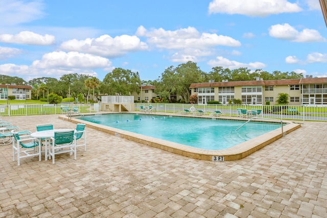 view of swimming pool featuring a patio area