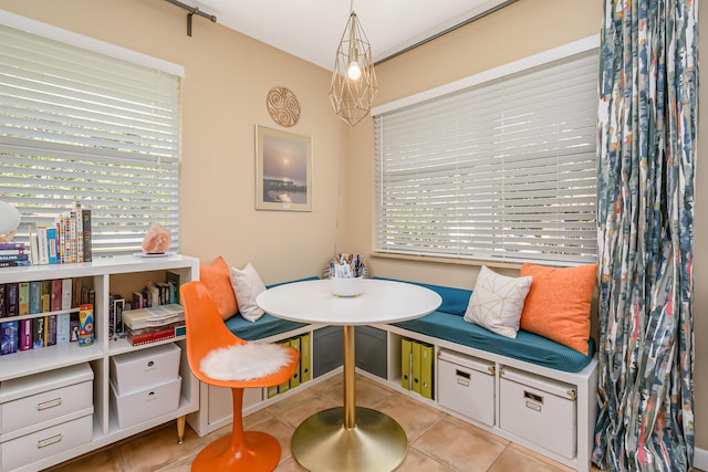 living area with breakfast area and light tile patterned floors