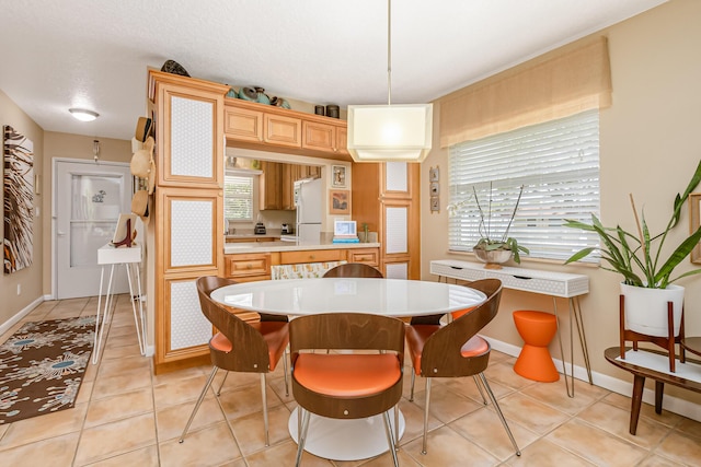 dining area with light tile patterned floors