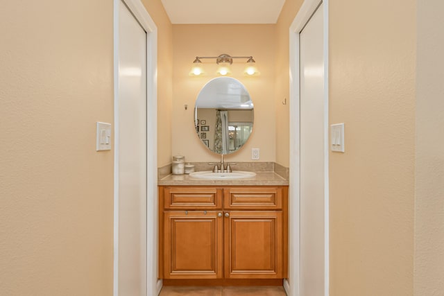 bathroom featuring tile patterned flooring and vanity