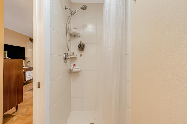 bathroom with tile patterned floors and walk in shower