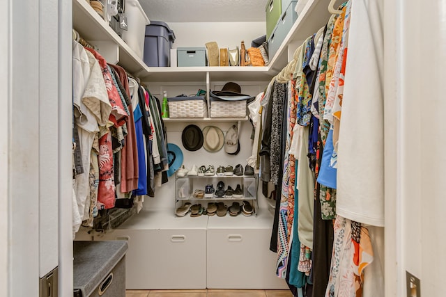 spacious closet with tile patterned floors