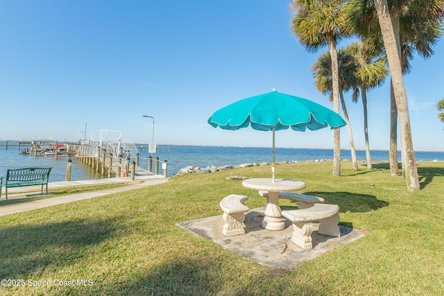 view of yard with a water view and a boat dock