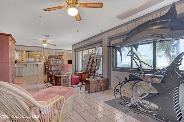 tiled living room with ceiling fan