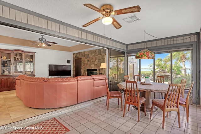 dining area with light tile patterned floors, ceiling fan, and a healthy amount of sunlight